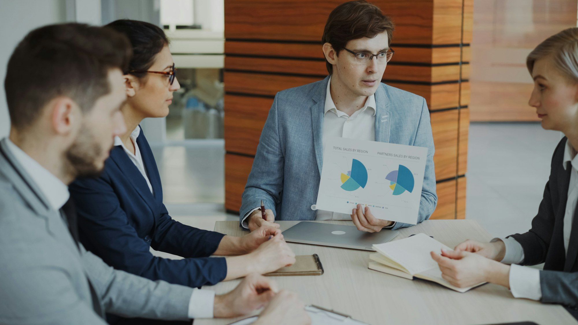 A business owner discussing hiring needs in a meeting